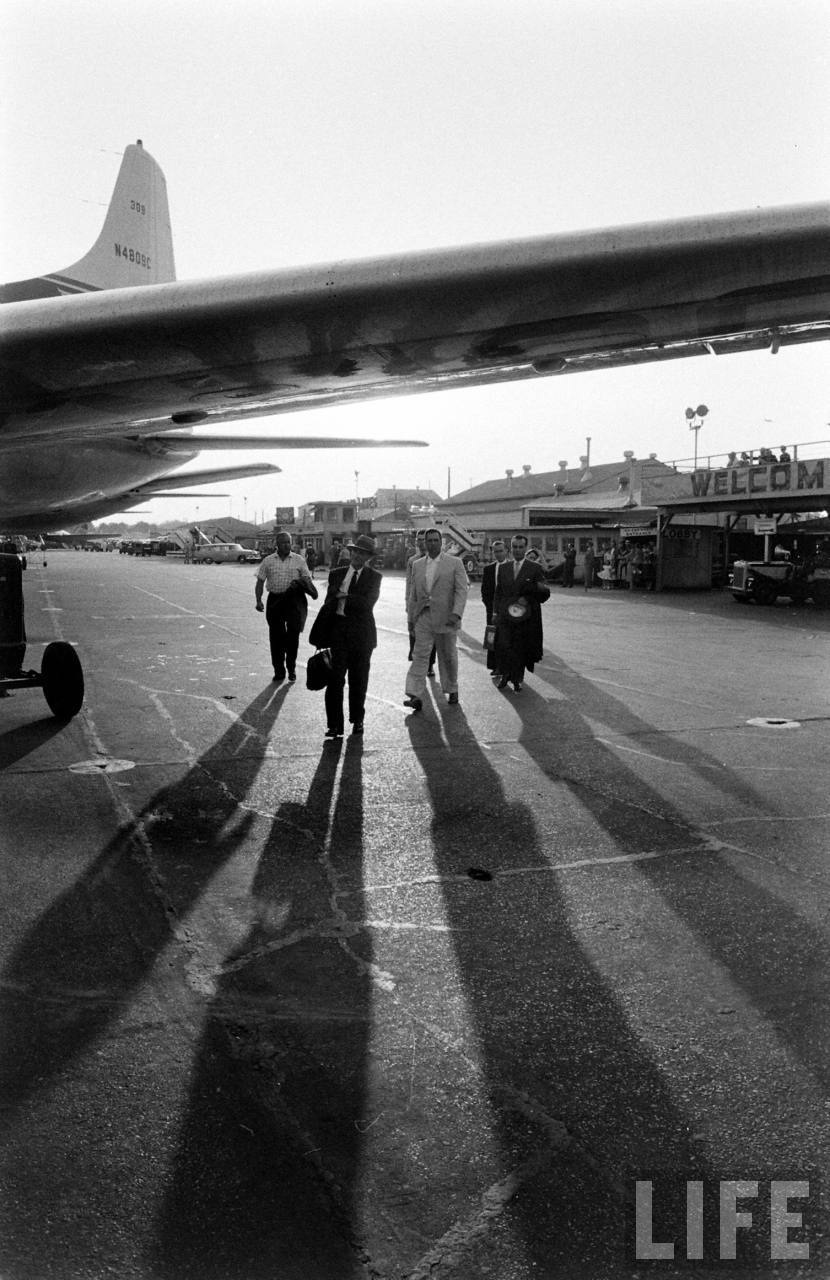 Passengers walk out to board Delta Airlines Convair 440 N4809C as the sun begins to set.