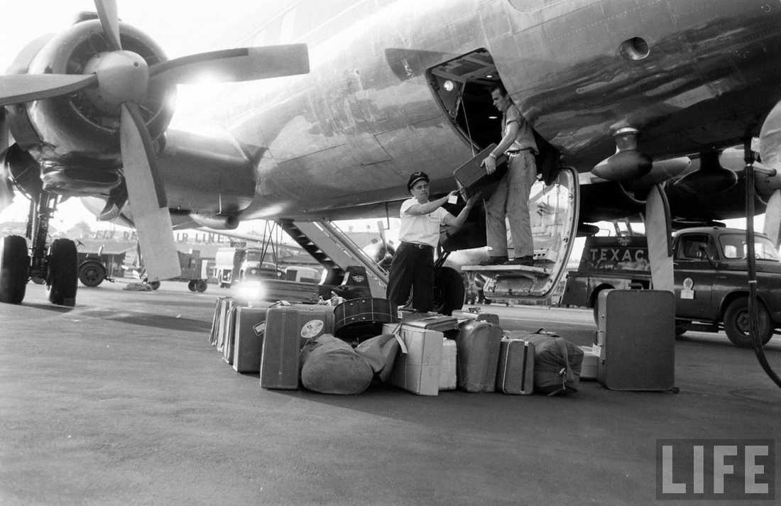 Unloading luggage from a Delta Airlines Douglas DC-7.