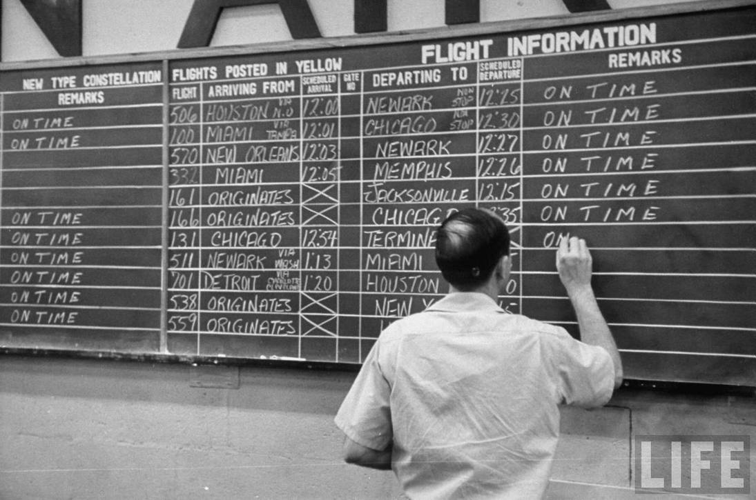 Before the days of computers: Eastern Air Lines arrivals and departures handwritten in chalk.