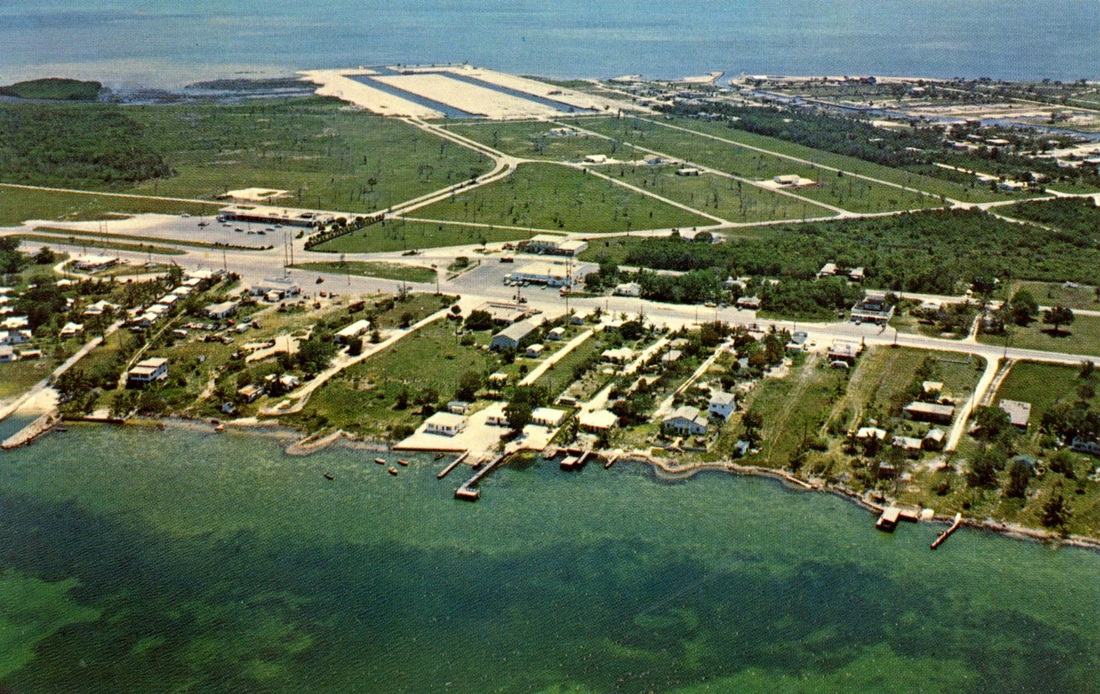 This late '50s / early '60s aerial postcard view of Key Largo around mile marker 99.5 shows the initial phase of the Port Largo development at the top of the photo. 