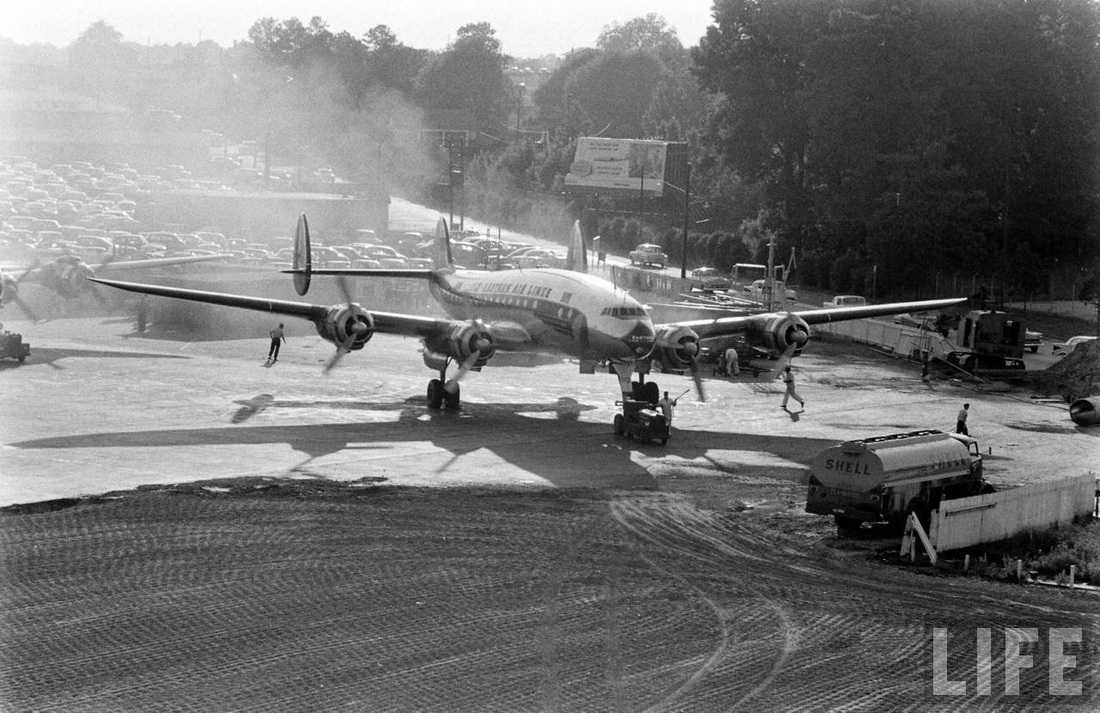 The ground crew scurries as all four engines come to life on an Eastern Air Lines Constellation at Atlanta in 1956..