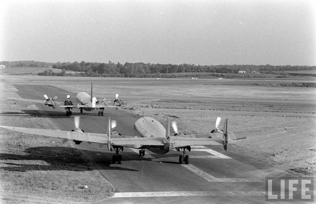 Eastern Air Lines Douglas DC-7 and Lockheed Constellation taxiing out to the runway.